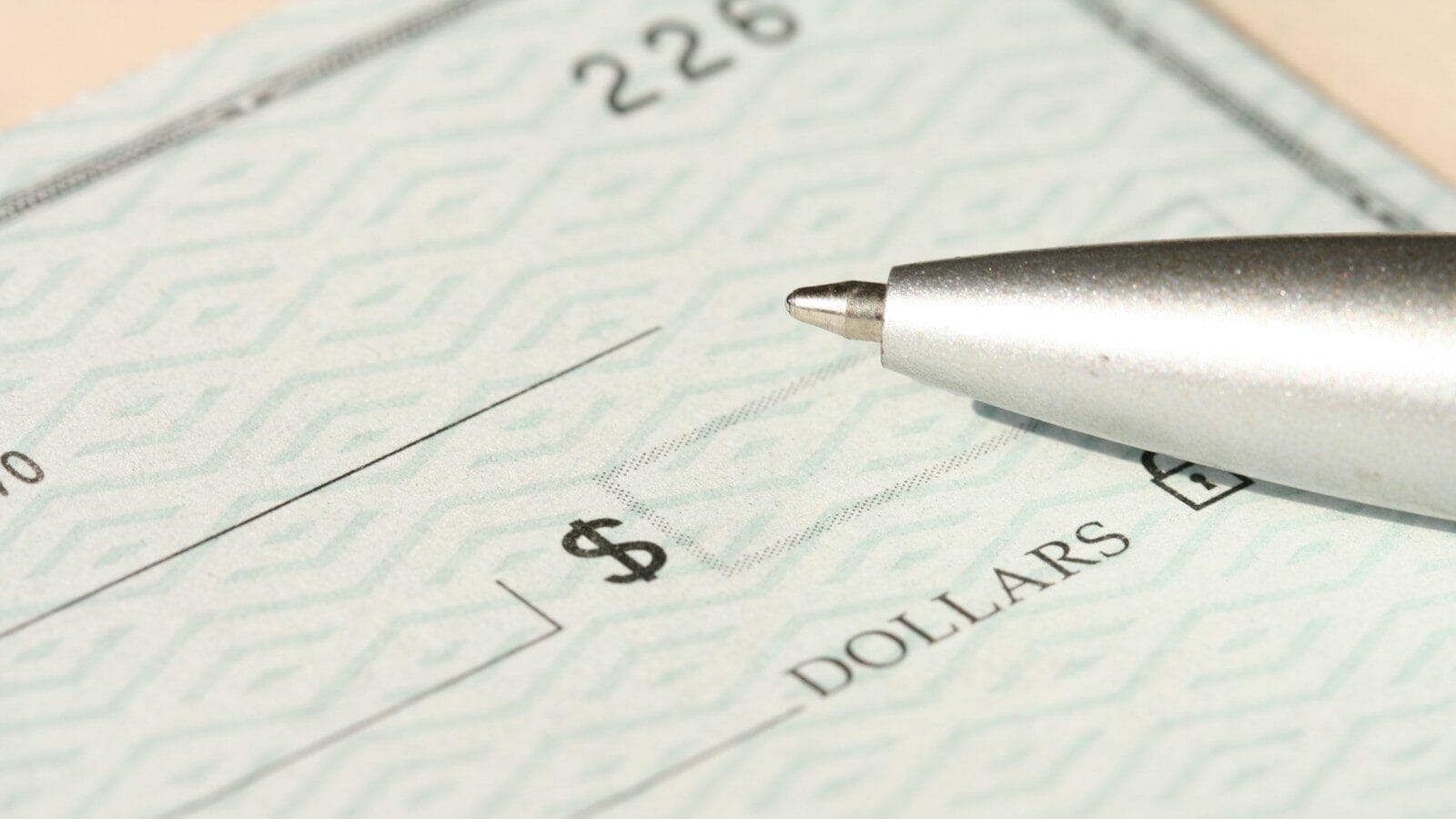 a pen sitting on top of a cheque paper